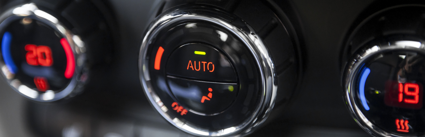 Color detail with the air conditioning button inside a car.